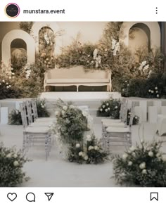 an outdoor ceremony setup with white chairs and flowers