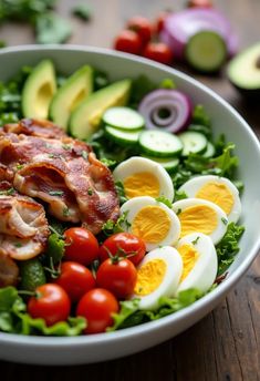 Close-up photo of a vibrant salad with grilled chicken, turkey bacon, cherry tomatoes, hard-boiled eggs, cucumber, red onion, avocado, and leafy greens in a white bowl on a rustic wooden table. Juicy Grilled Chicken Breast, Juicy Grilled Chicken, Grilled Chicken Breast, Bacon Salad, Refreshing Salad, White Bowl, Turkey Bacon, Healthy Salad, Light Lunch