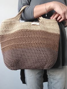 This crochet bag is a lovely handmade accessory that can be used to go grocery shopping, to go to the beach or to carry your stuff. It is an ideal gift for any occasion. This stylish shoulder bag offers plenty of room to store your things. It is opened at the top without inside lining Material: The bag is made out of 3mm polyester cord Cleaning and care: I recommend washing by hand with cold water and neutral soap. Leave to dry stretched out on a towel. Do not use a dryer machine. For more inten Crochet Double Handle Straw Bag For Daily Use, Big Shopper Bag, Crochet Totes, Handmade Tote Bags, Unique Tote Bag, Knitting Group, Shopper Bags, Brown Tote Bag, Stylish Tote Bag