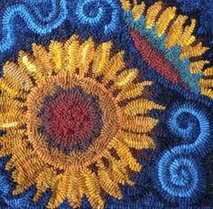 a close up view of a rug with flowers and swirls in the center on blue ground