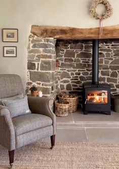 a living room with a fire place next to a chair and a basket on the floor