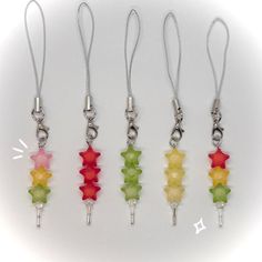 four different colors of glass beads hanging from silver chains