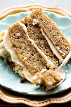 a slice of banana layer cake on a blue plate with a fork in the middle