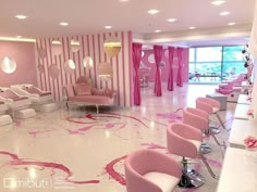 a pink and white salon with lots of chairs