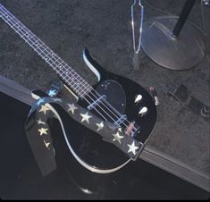 an electric bass guitar with stars on it