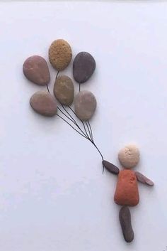 a person is holding some rocks and balloons