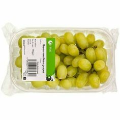 green grapes in a plastic container on a white background