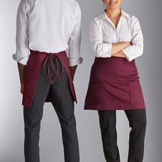 two people in aprons standing next to each other with their hands on their hips