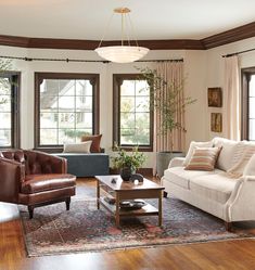 a living room filled with furniture and windows