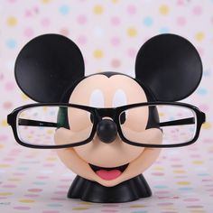 a close up of a mickey mouse with eyeglasses on it's head