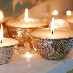 happy diwali greeting card with lit candles on the shelf in front of it