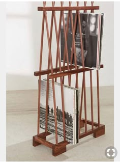 a wooden magazine rack holding several books and magazines