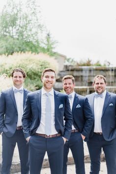 a group of men in suits standing next to each other