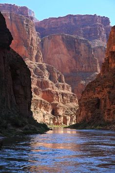 a river flowing through a canyon surrounded by mountains