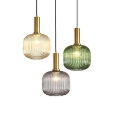 three glass pendant lights hanging from the ceiling