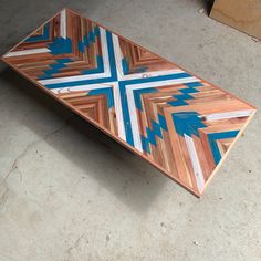 a wooden table with blue arrows painted on it