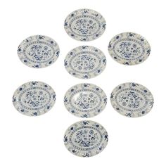 six blue and white plates with designs on them