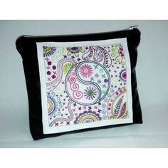 a black and white purse with a colorful paisley design on it's front pocket