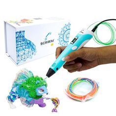 a person is holding a pen and some wires in front of the box with it's contents