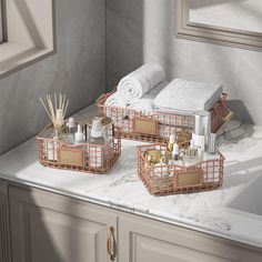 the bathroom is decorated in neutral tones and features gold accents, such as bamboo baskets with towels on them