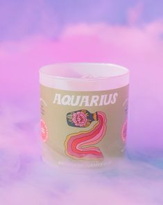 an aquarius coffee cup sitting on top of a pink and purple background with the words aquarius