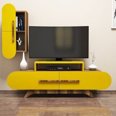 a yellow entertainment center with a flat screen tv on it's stand in front of a white wall