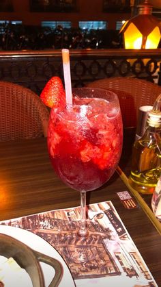 a drink with strawberries in it sitting on a table