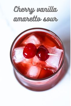 two cherries on top of ice in a glass with the words cherry vanilla amaretto sour