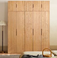 a bedroom with a bed and wooden cabinets