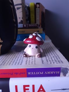 a small mushroom sitting on top of some books