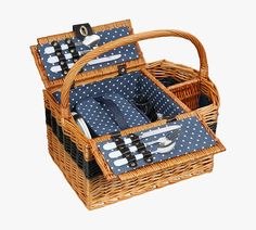 two wicker picnic baskets with blue and white polka dot napkins, forks and spoons