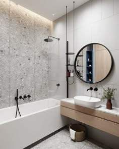 a bathroom with two sinks and a large mirror on the wall above the bathtub