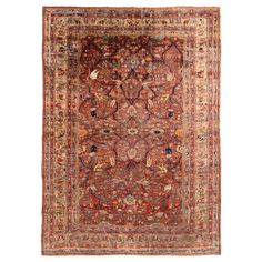 an antique persian rug with red and blue colors