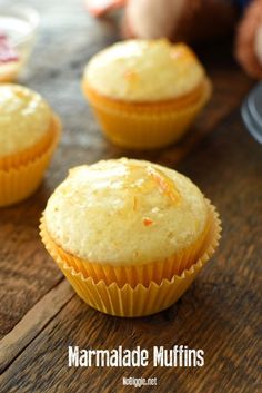 three muffins sitting on top of a wooden table