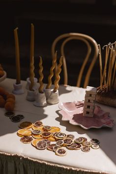 a table topped with lots of buttons and candles