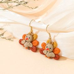 a pair of earrings with an animal on it