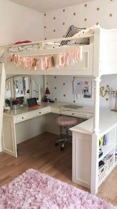 a white bunk bed sitting next to a pink rug on top of a hard wood floor