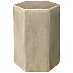 a white square vase sitting on top of a table