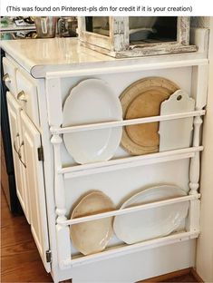 a white cabinet with plates and pans on it