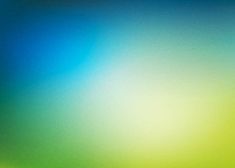 a blurry image of green, yellow and blue colors on a wallpaper background