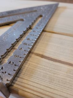 a large metal ruler sitting on top of a wooden table