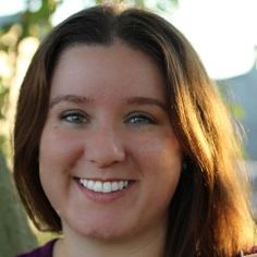 a close up of a person smiling for the camera