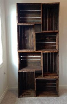 a bookcase made out of wooden crates in a room