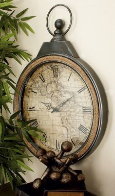 an old world map is displayed on top of a shelf next to a potted plant