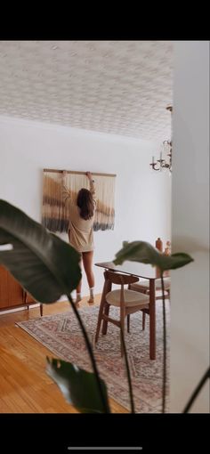 a woman standing in the middle of a living room