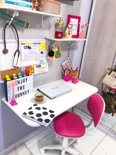 a white desk topped with a laptop computer next to a shelf filled with office supplies