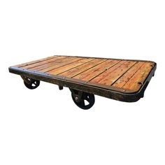 an old wooden table with wheels is shown on a white background for use as a coffee table or serving tray