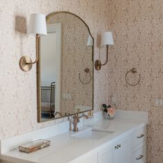 a bathroom with two sinks and a large mirror on the wall next to each other