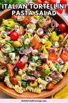 a bowl filled with pasta salad next to tomatoes and olives on the side text reads italian tortelli pasta pasta