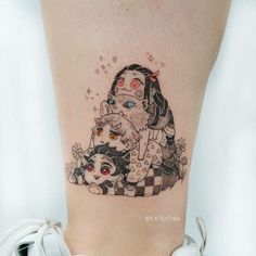 a woman's leg with a tattoo on it that has an image of two cats and a dog